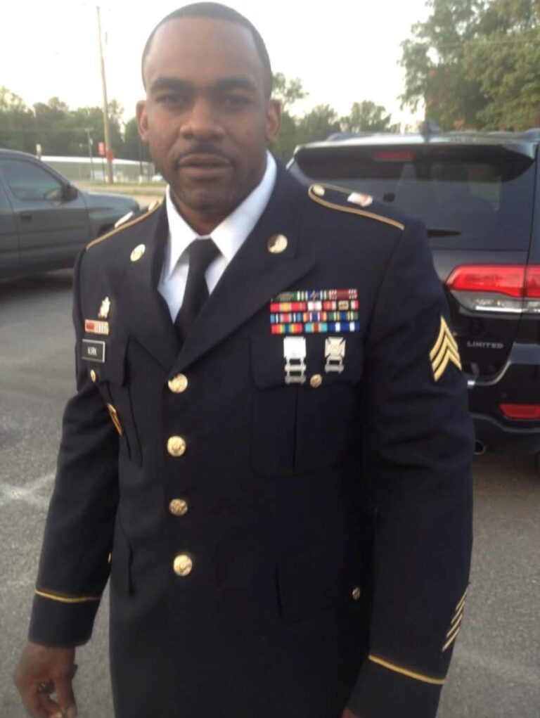 Man in military uniform with medals.