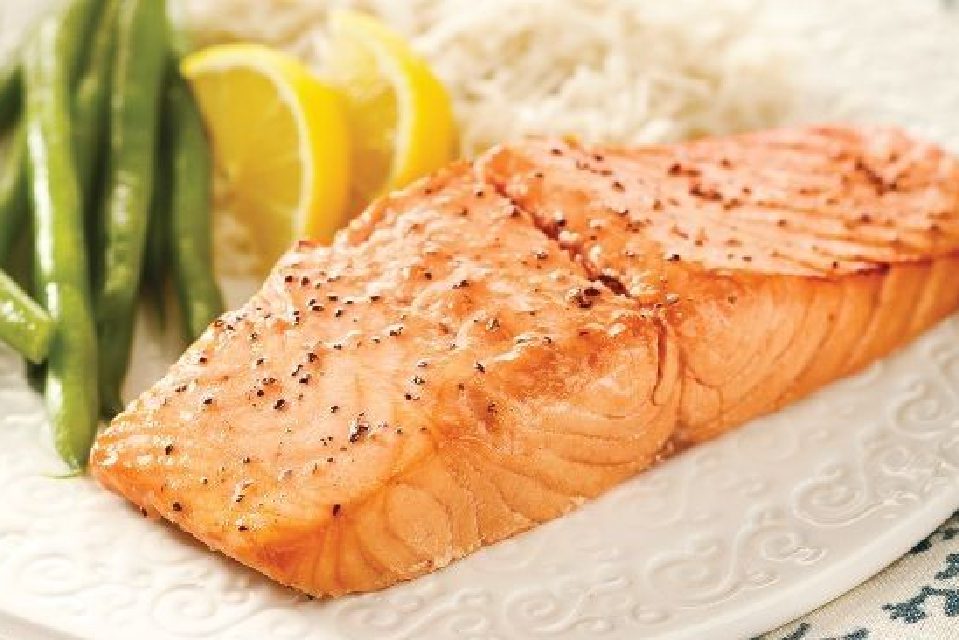 A piece of salmon is on the plate.