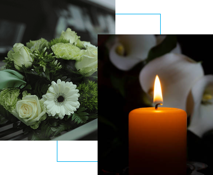 A candle and flowers are in front of a picture.