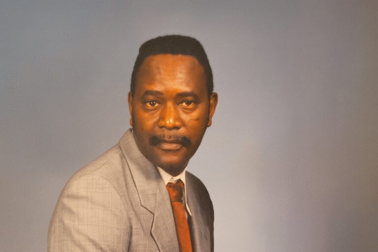 Man in gray suit with red tie.