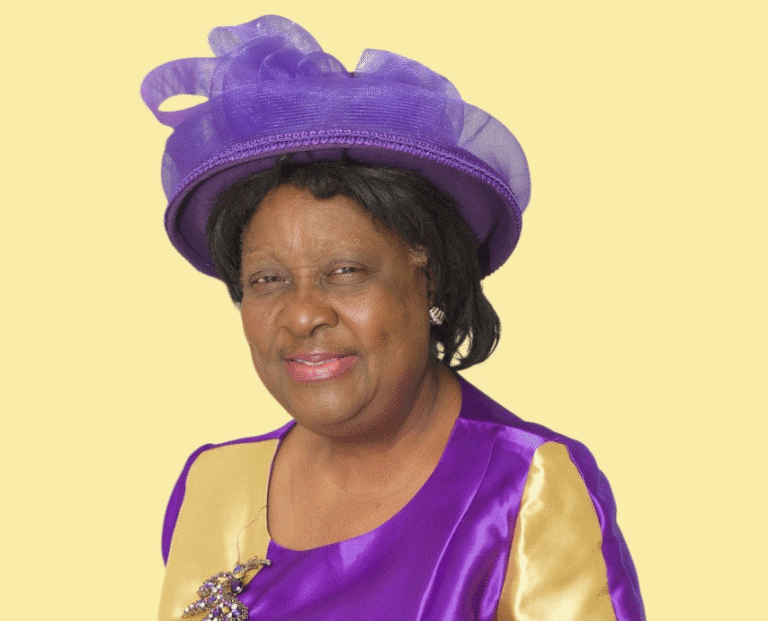 Woman in purple outfit with matching hat.